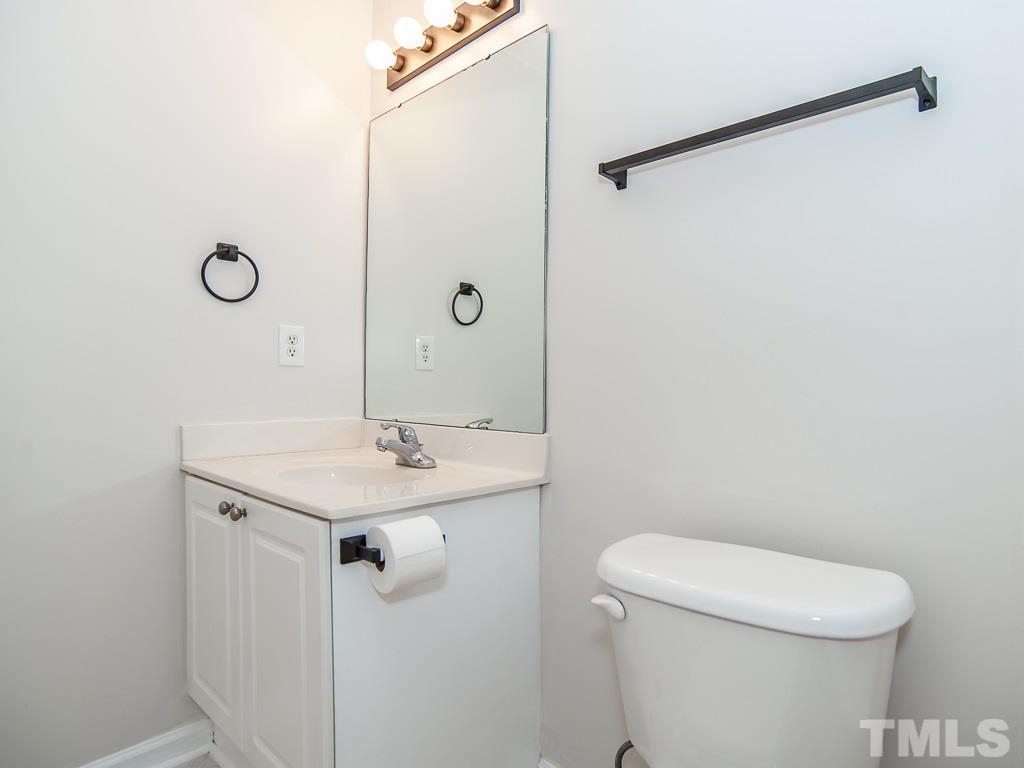 3824 Pin Oak Road Raleigh, NC 27604 - Photo 23 of 27 a bathroom with a sink a toilet a mirror and shower