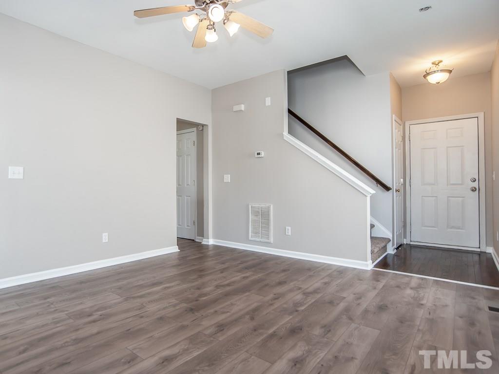 3824 Pin Oak Road Raleigh, NC 27604 - Photo 5 of 27 an empty room with wooden floor and staircase