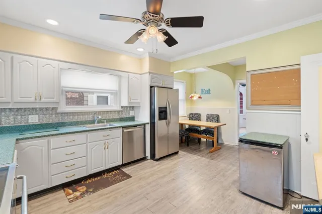 a kitchen with sink cabinets and refrigerator