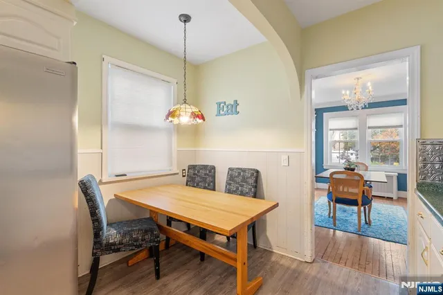a view of a dining room with furniture and wooden floor
