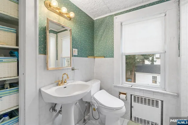 a bathroom with a sink toilet and mirror