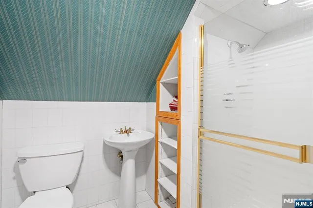 a bathroom with a sink a toilet and shower curtain