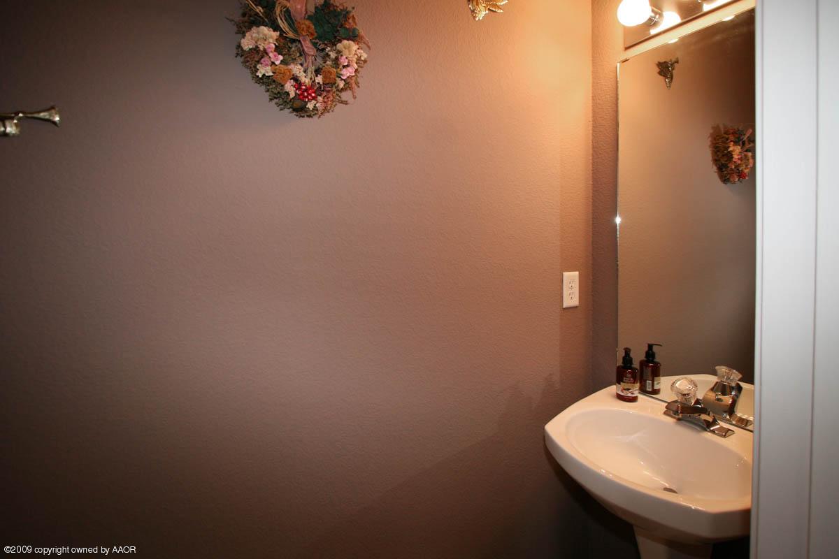 5101 Capulin Lane Amarillo, TX 79110 - Photo 22 of 23 a bathroom with a sink mirror and vanity