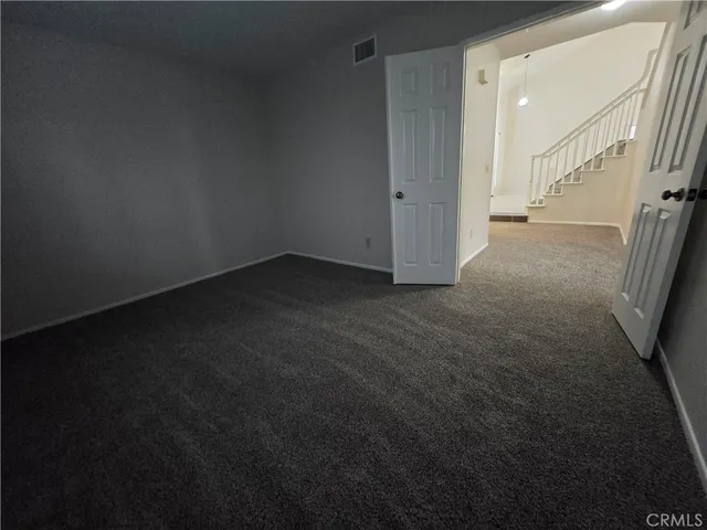 an empty room with fireplace and windows