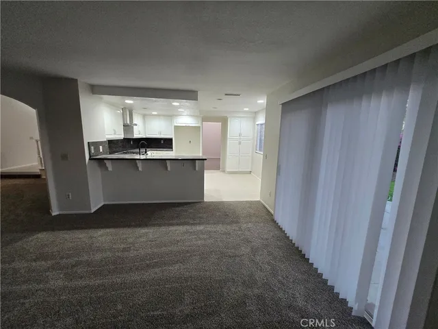 a kitchen with kitchen island sink refrigerator and cabinets