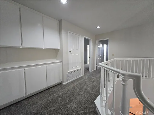 a view of staircase with white walls and window