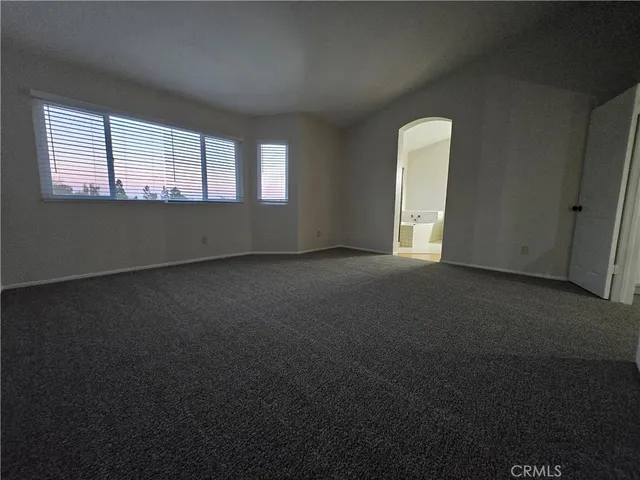 a view of an empty room and closet area