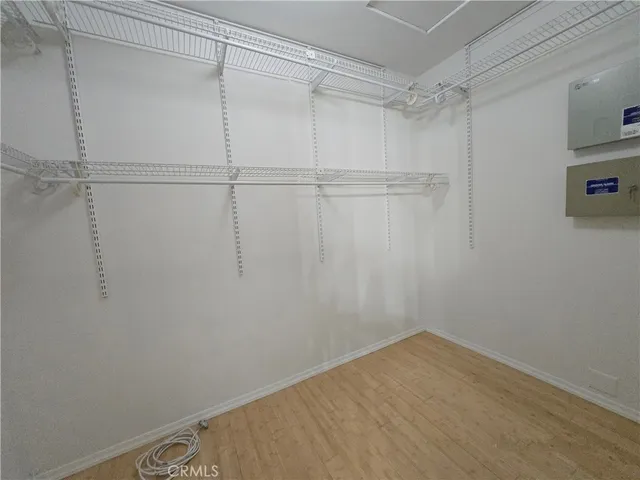 a view of a hallway with wooden floor and stairs