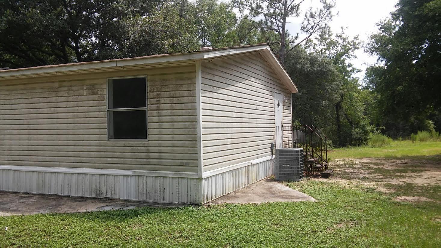 4353 Richardson Road Crestview, FL 32539 - Photo 15 of 15 a backyard of a house with lots of green space