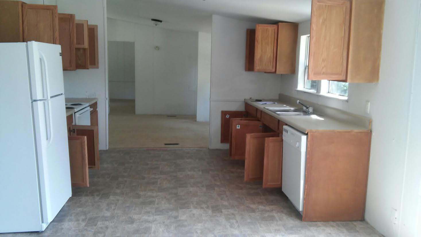 4353 Richardson Road Crestview, FL 32539 - Photo 8 of 15 a kitchen with a refrigerator and a sink