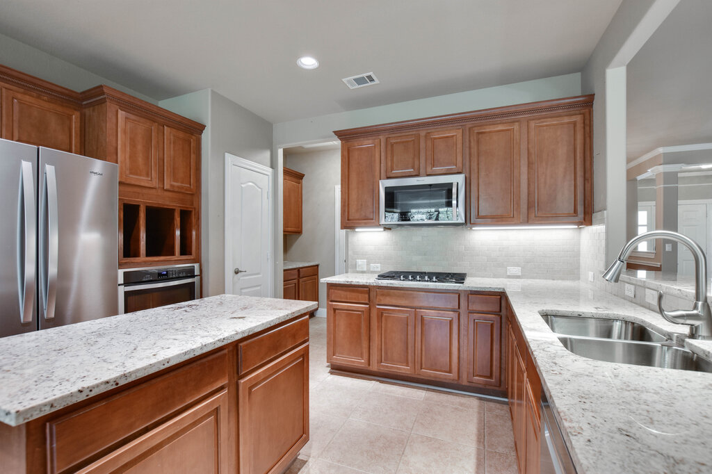 735 Breezeway Lane Georgetown, TX 78633 - Photo 12 of 33 Kitchen featuring light granite countertops.