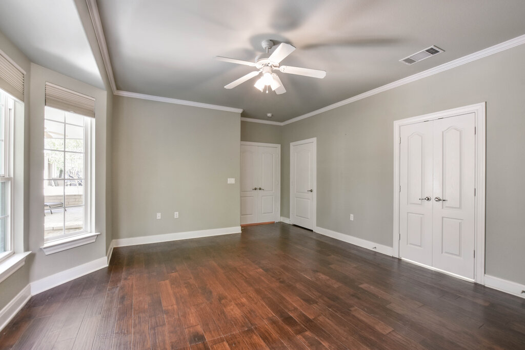 735 Breezeway Lane Georgetown, TX 78633 - Photo 20 of 33 Unfurnished bedroom with dark wood-style floors, multiple closets, ceiling fan, and crown molding