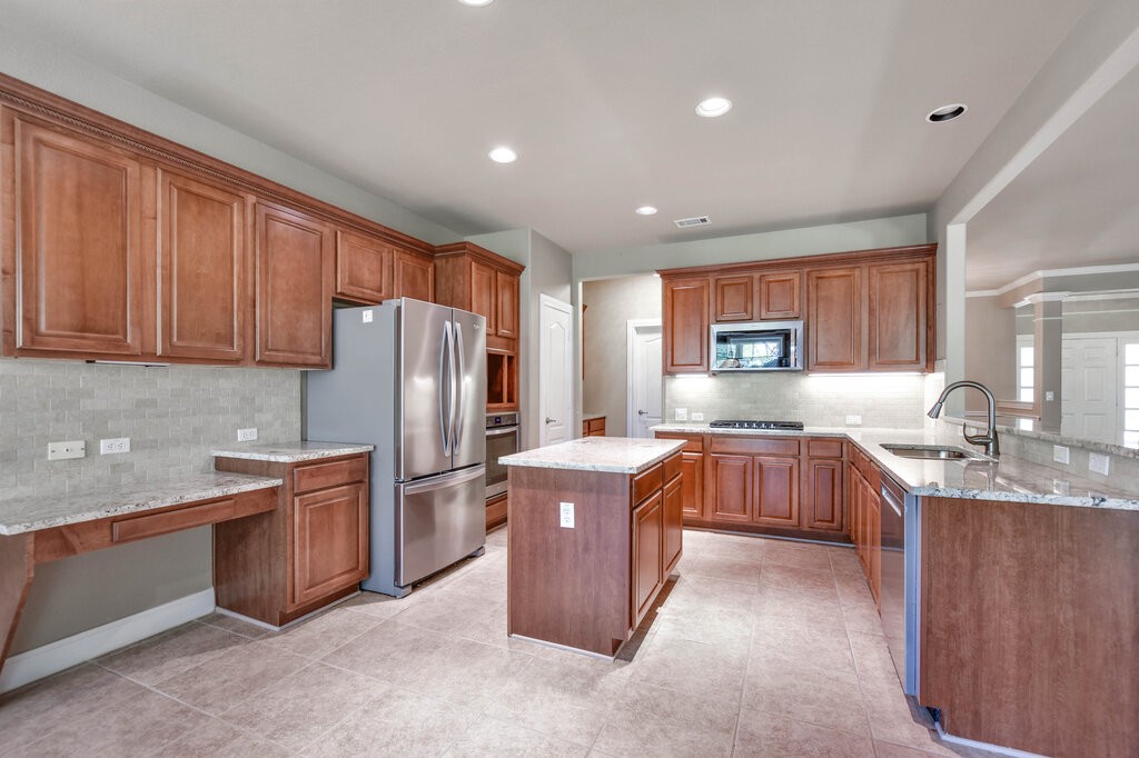 735 Breezeway Lane Georgetown, TX 78633 - Photo 10 of 33 Kitchen with island, built-in stainless steel appliances, and recessed lighting