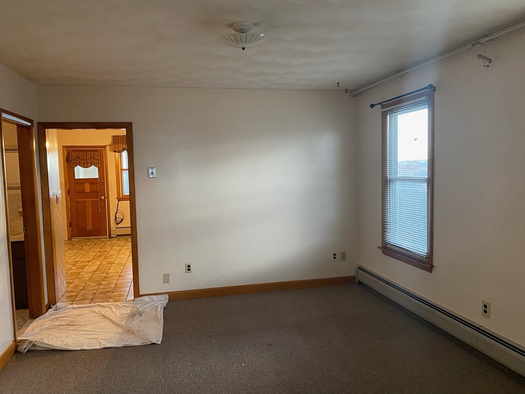 237 Lexington Street, Unit 3 Boston, MA 02128 - Photo 8 of 13 an empty room with windows