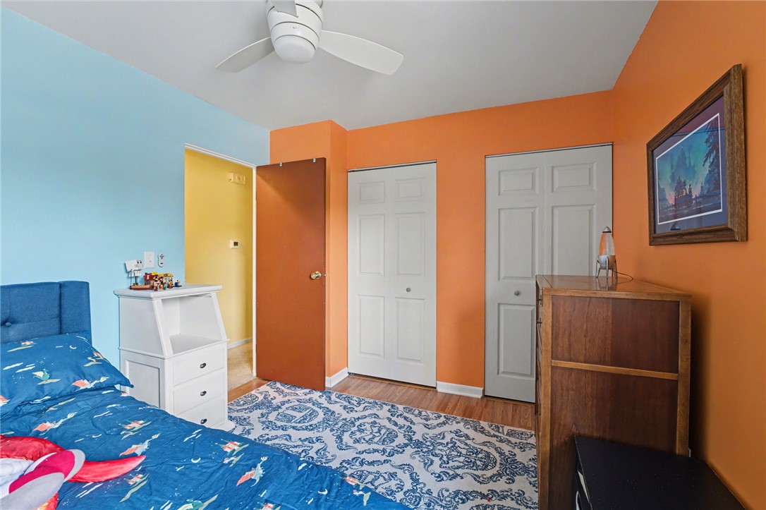 4919 Silver Arrow Drive Riverside, OH 45424 - Photo 23 of 57 This spacious bedroom features warm wood flooring and bright, inviting walls, creating a cozy atmosphere.