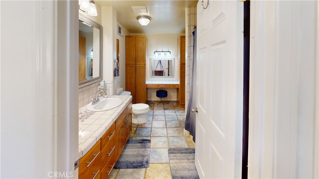 41257 Crest Drive Hemet, CA 92544 - Photo 25 of 53 Primary Bathroom with extra cabinets and makeup area.