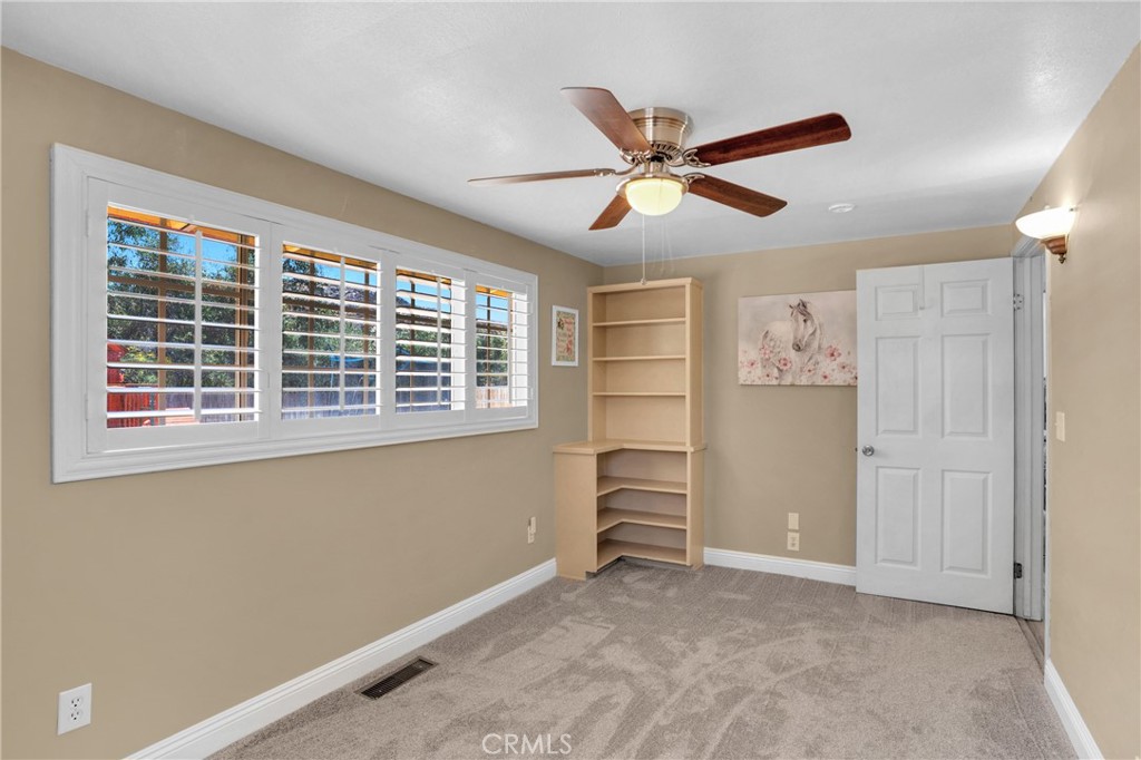 41257 Crest Drive Hemet, CA 92544 - Photo 29 of 53 Third bedroom wood shutters and built in book case.