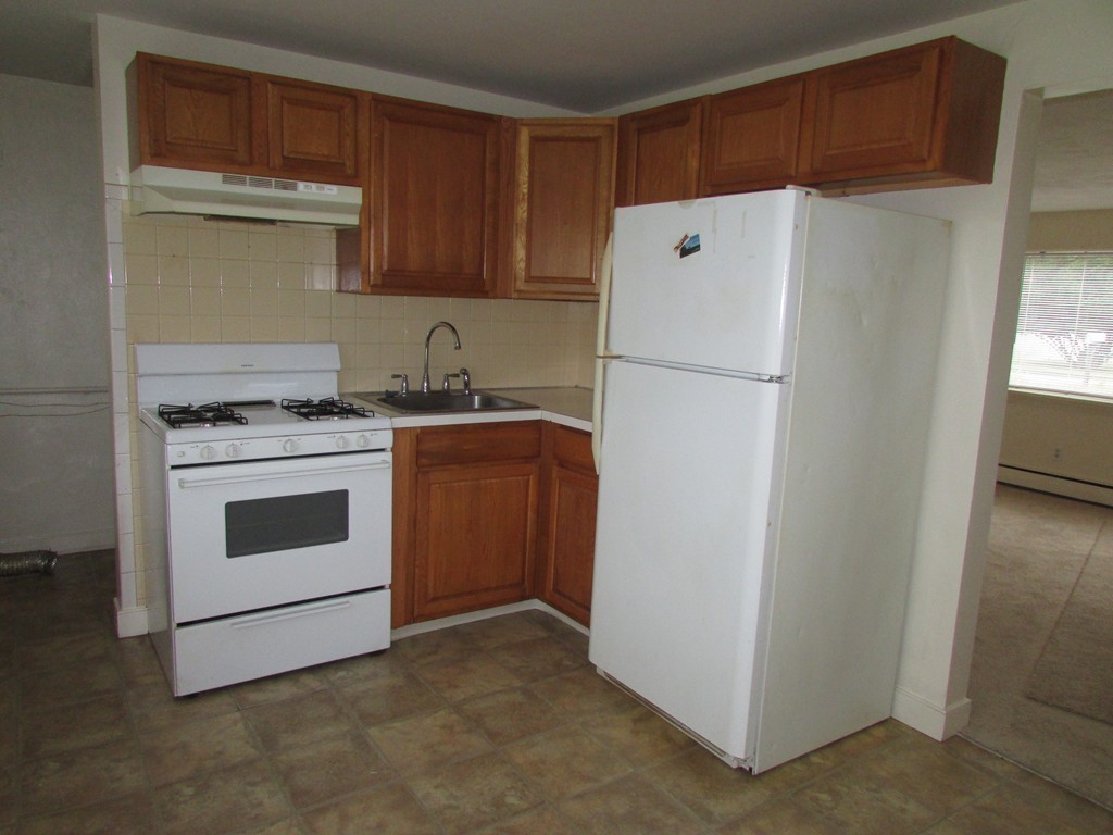 12 Chatham Road Billerica, MA 01821 - Photo 3 of 16 a white refrigerator freezer sitting in a kitchen
