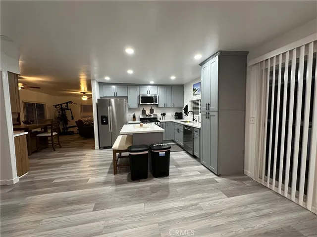 a view of a livingroom with wooden floor and a fireplace