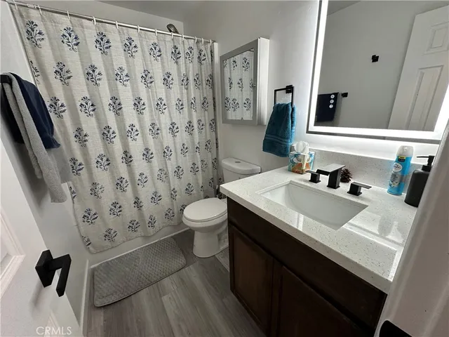 a large bedroom with a bed and a television