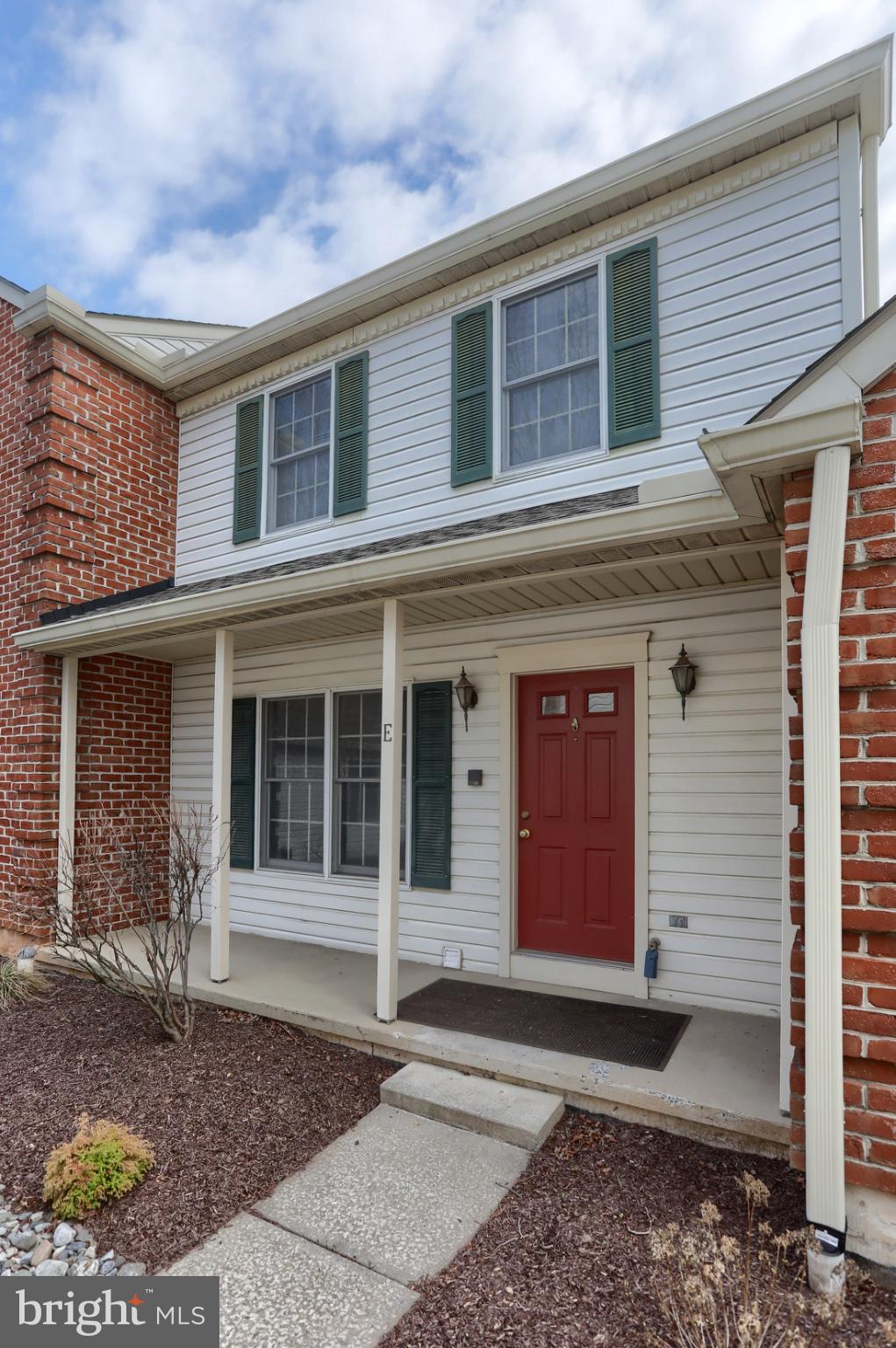 Charming entryway with vibrant red door.
