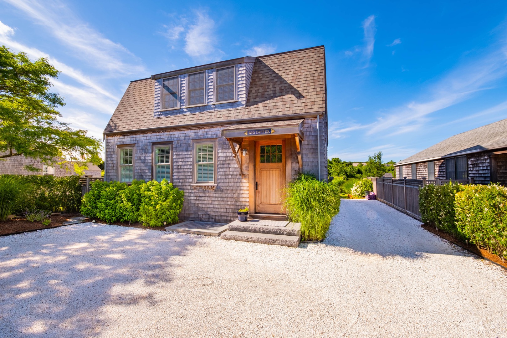 33.5 Vesper Lane Nantucket, MA 02554 - Photo 3 of 55 a front view of a house with a yard and garage