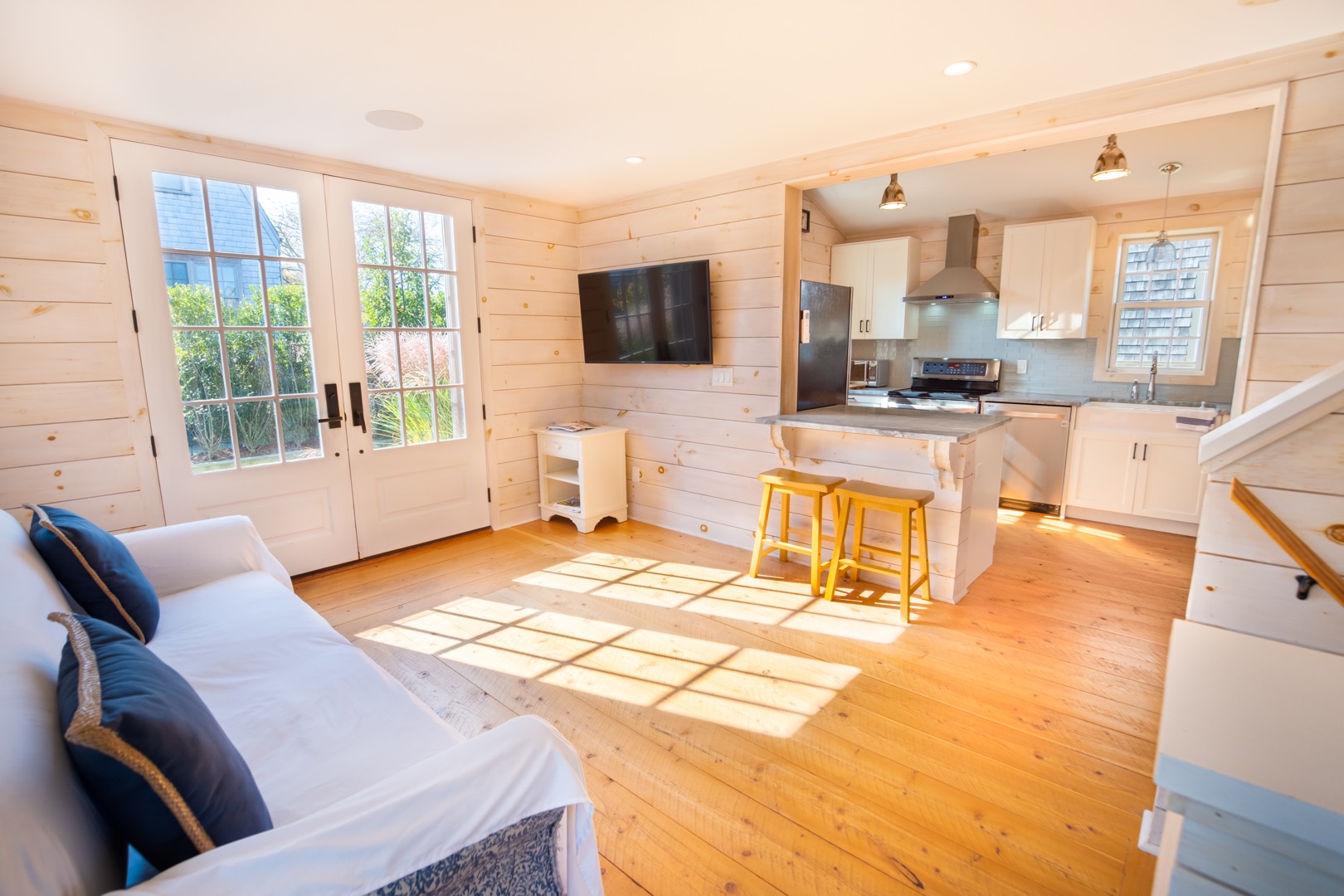33.5 Vesper Lane Nantucket, MA 02554 - Photo 45 of 55 a living room with a couch a dining table and a flat screen tv