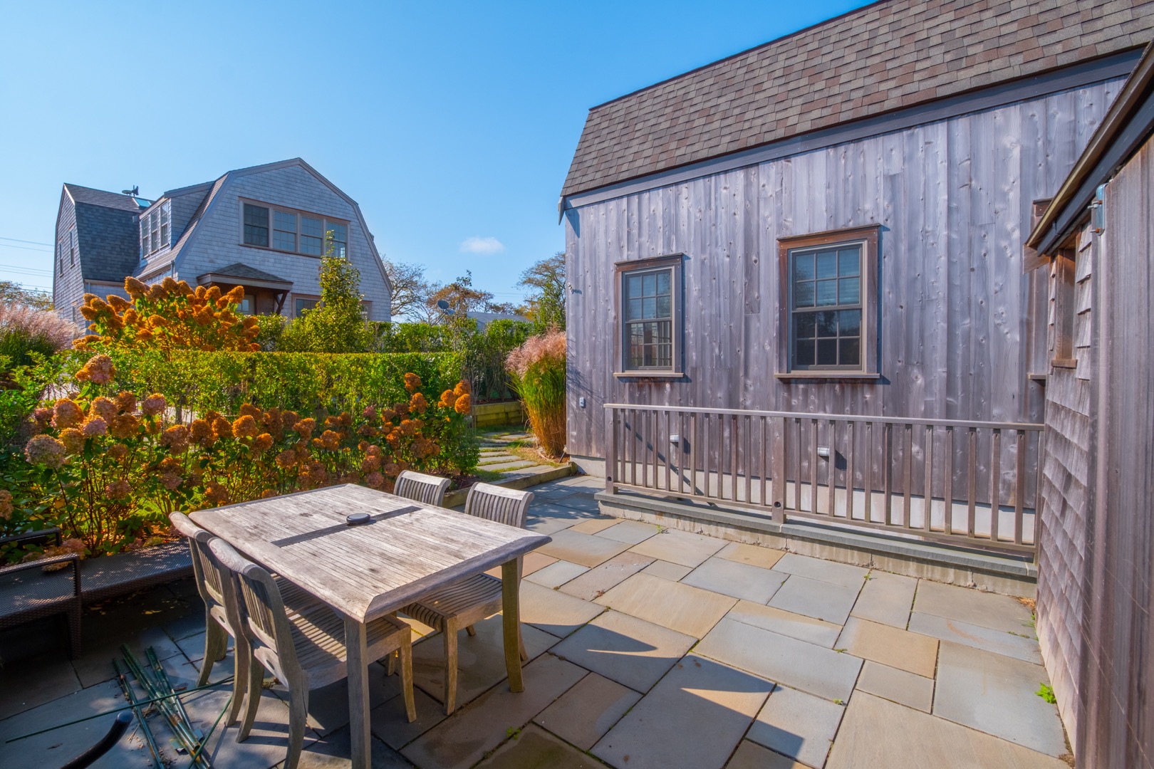 33.5 Vesper Lane Nantucket, MA 02554 - Photo 55 of 55 a view of a patio with table and chairs with wooden floor and fence