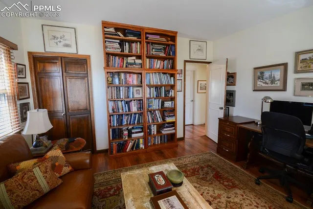 a living room with furniture and a book shelf