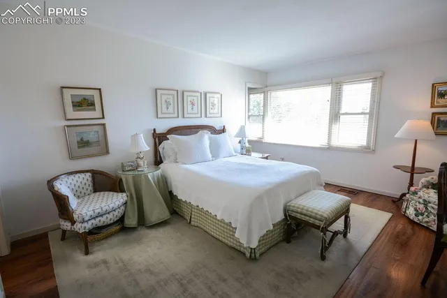 a spacious bedroom with a bed and a couch