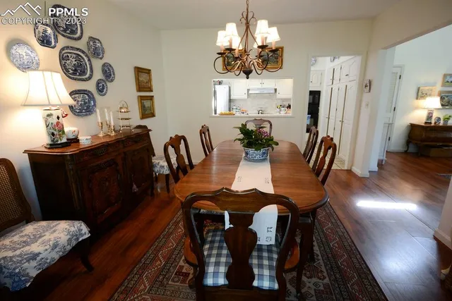 a view of a dining room with furniture and chandelier