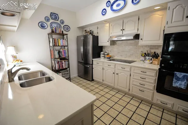 a kitchen with stainless steel appliances a refrigerator sink and cabinets