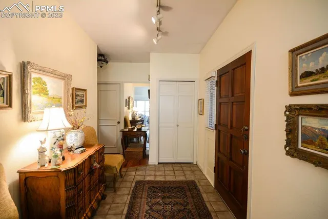 a hallway with furniture and wooden floor