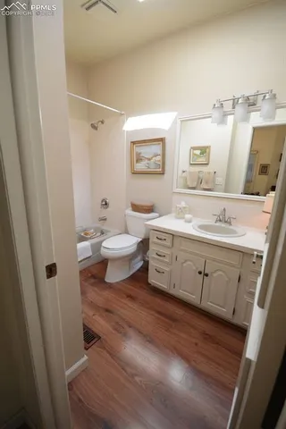 a bathroom with a double vanity sink toilet and shower