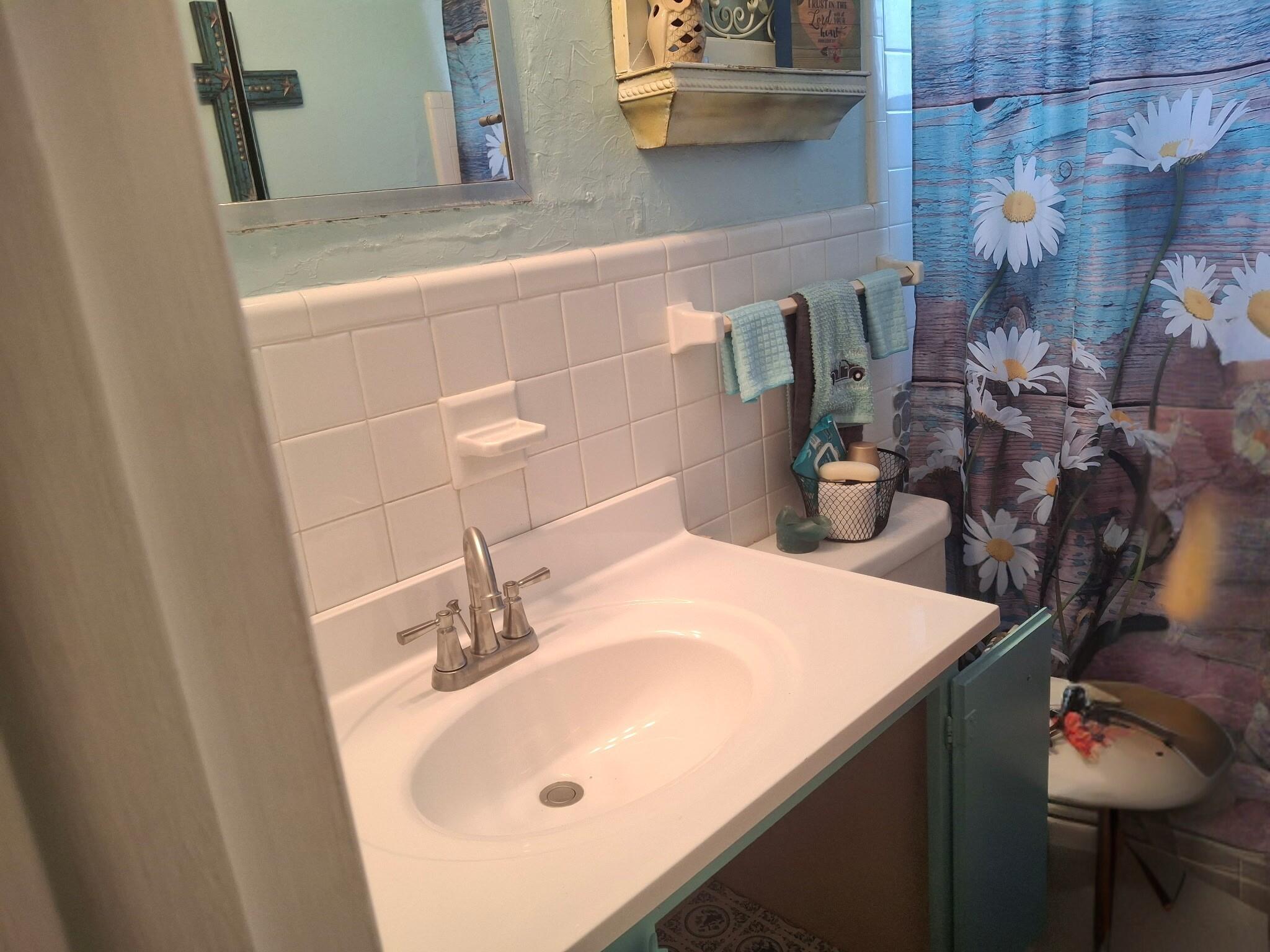 4820 Southwest 11th Street Plantation, FL 33317 - Photo 9 of 14 a bathroom with a sink and a mirror