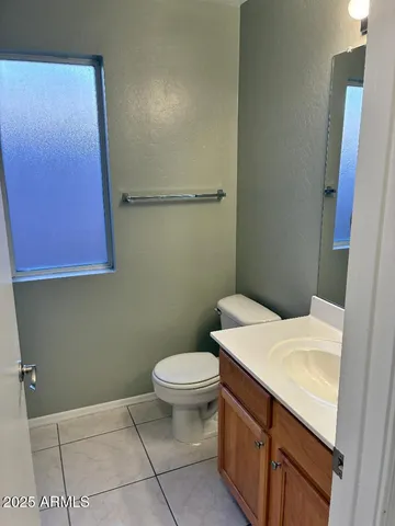 a bathroom with a sink a toilet and vanity