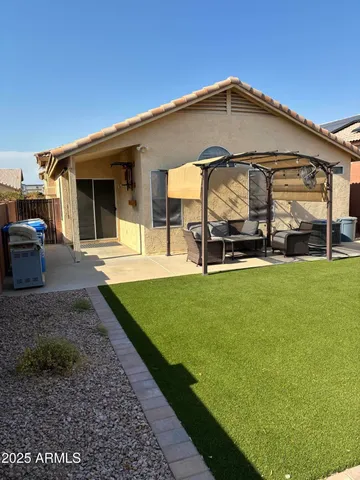 a view of a house with a backyard