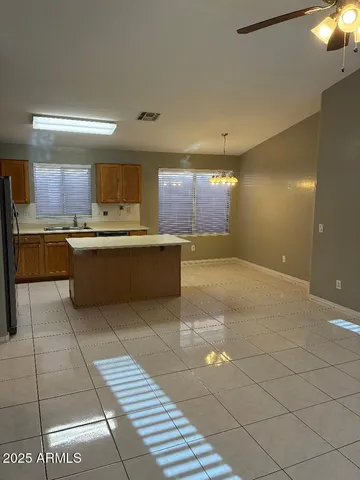 a large kitchen with kitchen island a sink stainless steel appliances and a counter top space