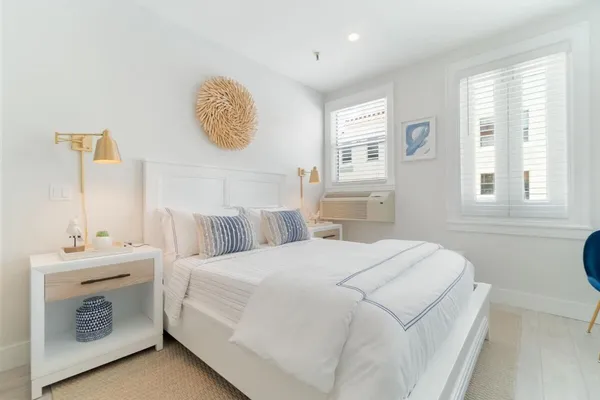 a bedroom with a bed and a table