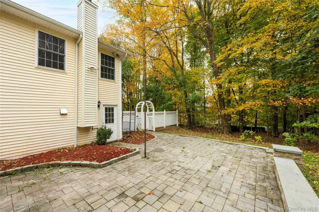 a view of backyard of house with seating space