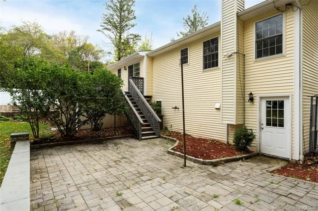 a view of a house with a yard patio and fire pit