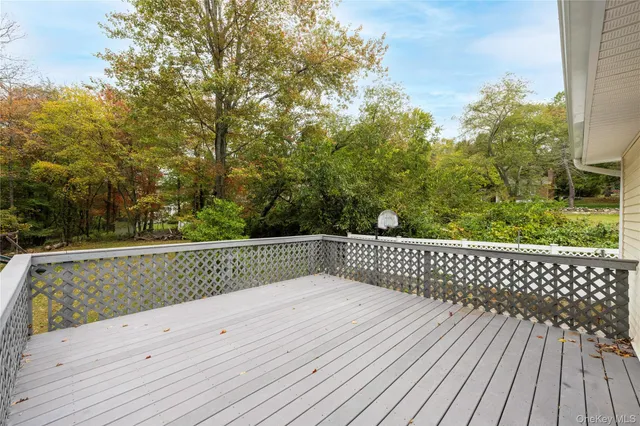 a view of a pathway with a bench next to a yard