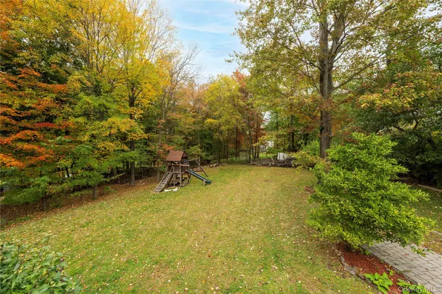 a view of yard with swimming pool and trees