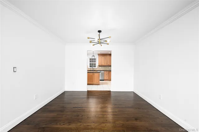 a view of a room with wooden floor and white walls