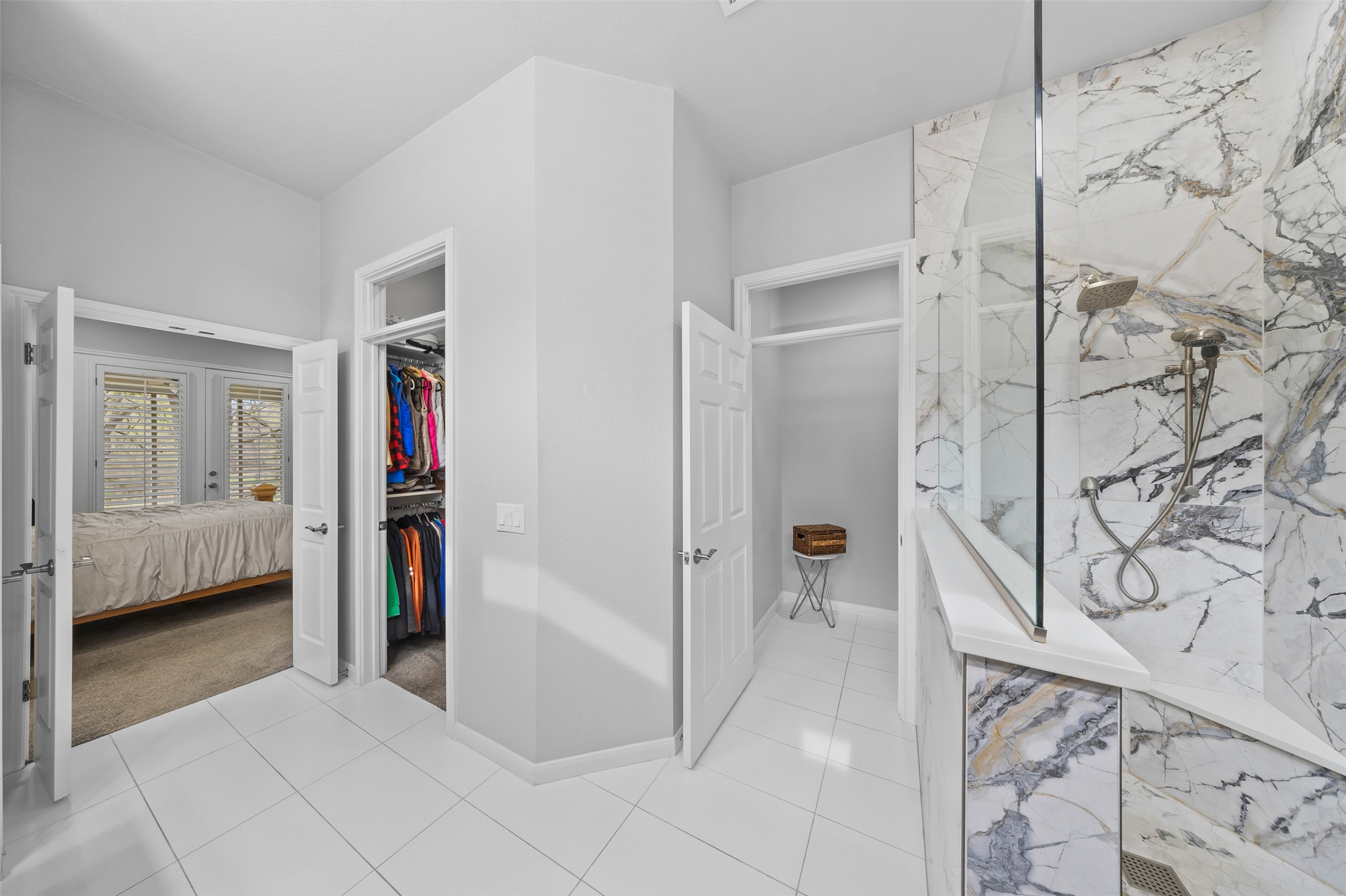 144 Stetson Trail Georgetown, TX 78633 - Photo 27 of 39 Ensuite bathroom featuring a marble finish shower with seating, a walk in closet, and light tile-patterned flooring