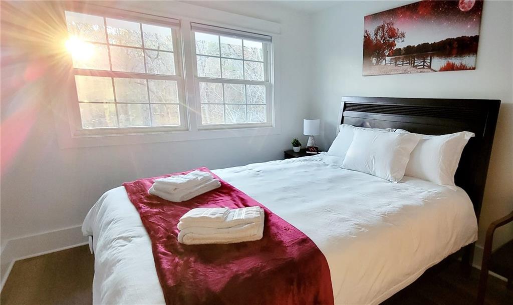 2900 Orchard Road Southwest Conyers, GA 30094 - Photo 20 of 63 a bedroom with a bed and wooden floor