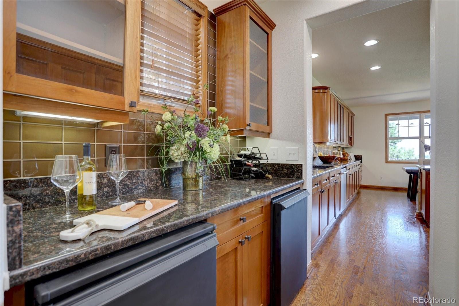 2795 Rockbridge Circle Highlands Ranch, CO 80129 - Photo 11 of 49 a kitchen with counter top space and wooden floor