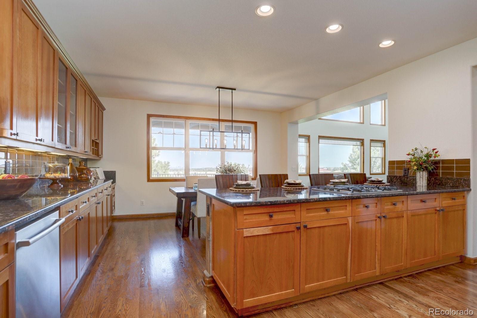2795 Rockbridge Circle Highlands Ranch, CO 80129 - Photo 12 of 49 a kitchen with granite countertop cabinets stainless steel appliances a sink and a large window