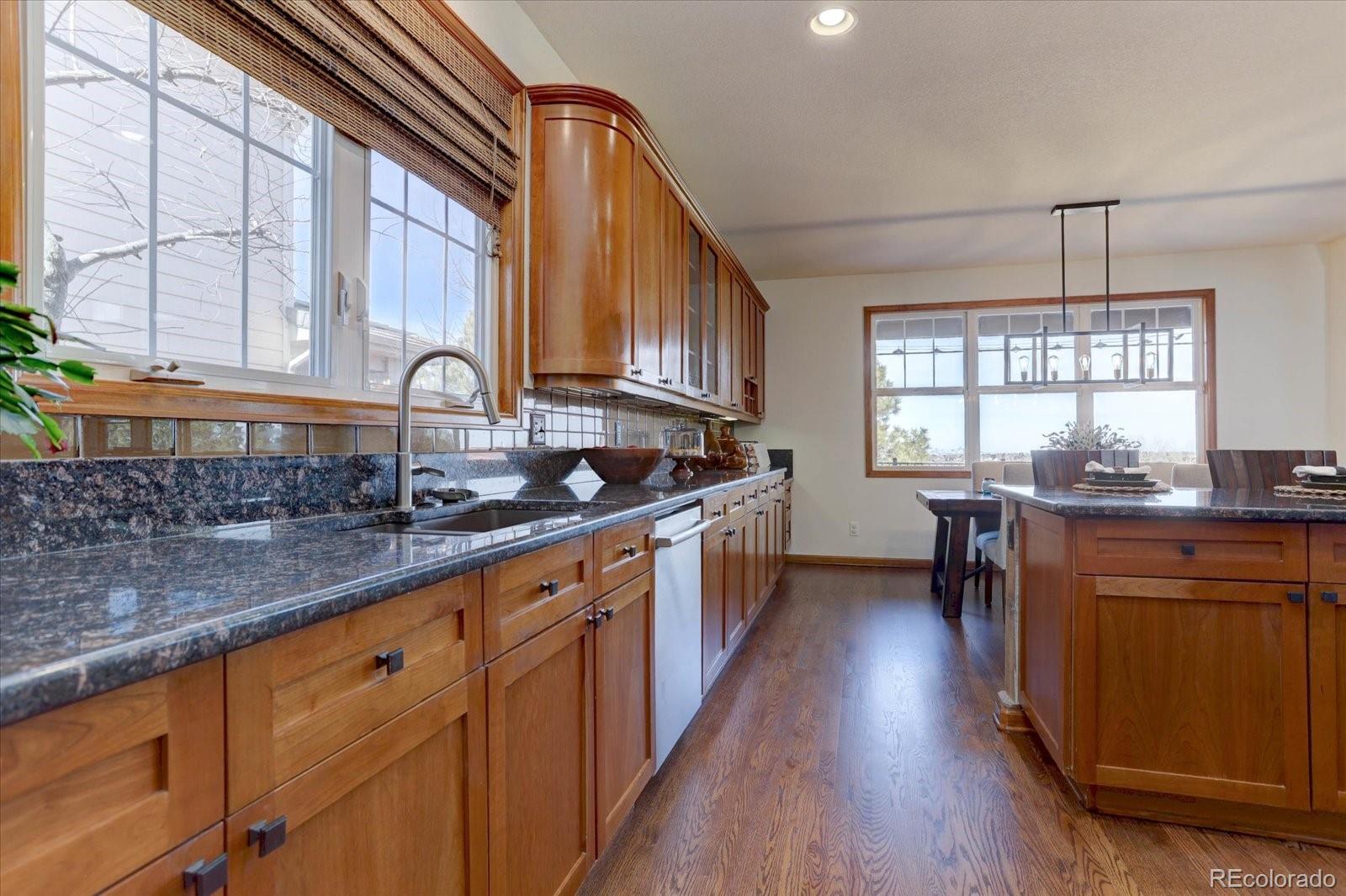 2795 Rockbridge Circle Highlands Ranch, CO 80129 - Photo 13 of 48 a kitchen with stainless steel appliances granite countertop wooden cabinets a sink and dishwasher