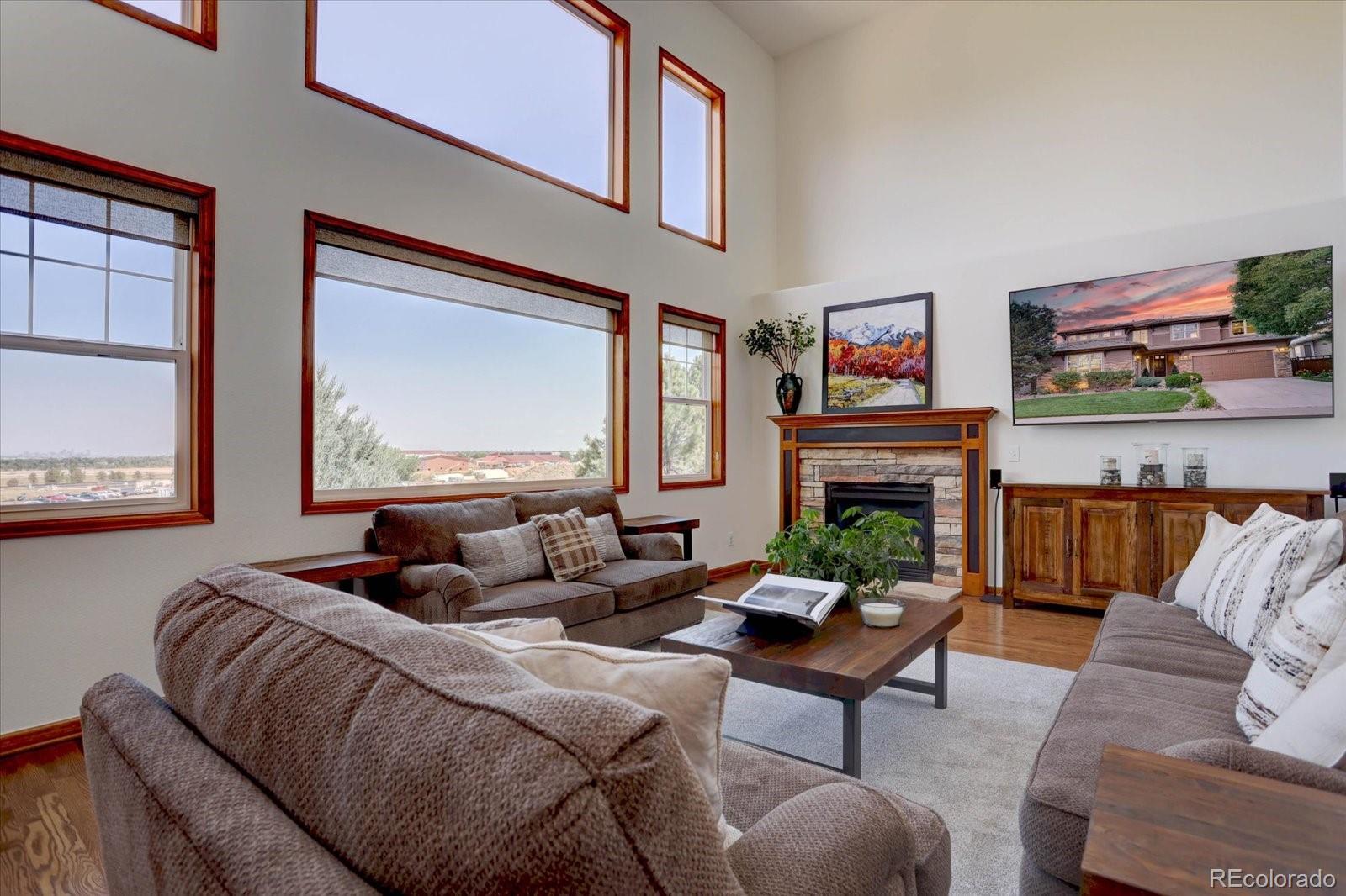 2795 Rockbridge Circle Highlands Ranch, CO 80129 - Photo 17 of 49 a living room with fireplace furniture and a large window